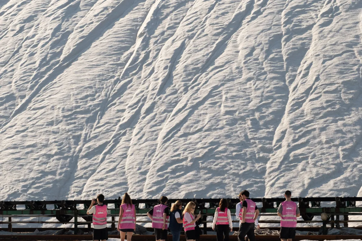 Gruppe Menschen vor einem grossen Salzberg