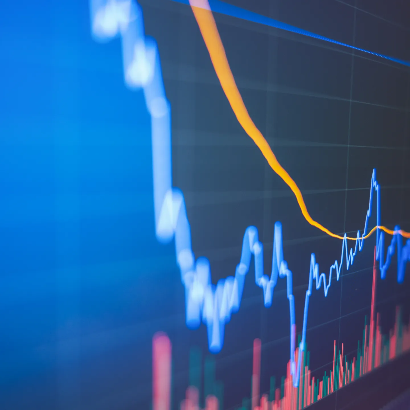 Finanzdiagramm mit blauer und orangefarbener Linie auf Bildschirm.
